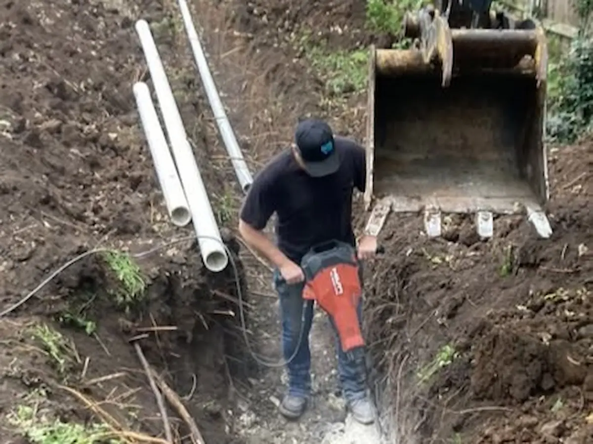 Excavator digging for sewer replacement in Butler County, KS